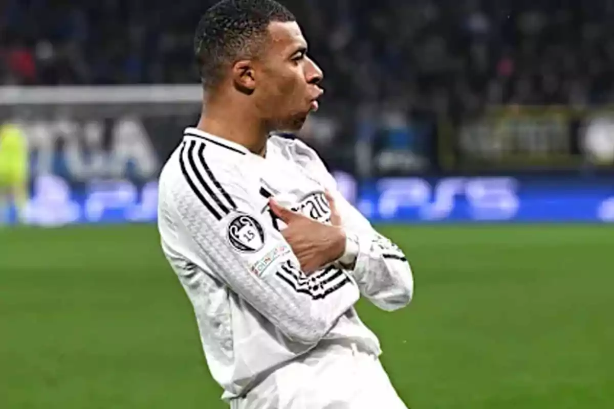 A soccer player in a white uniform celebrates on the field. A soccer player in a white uniform celebrates on the field.