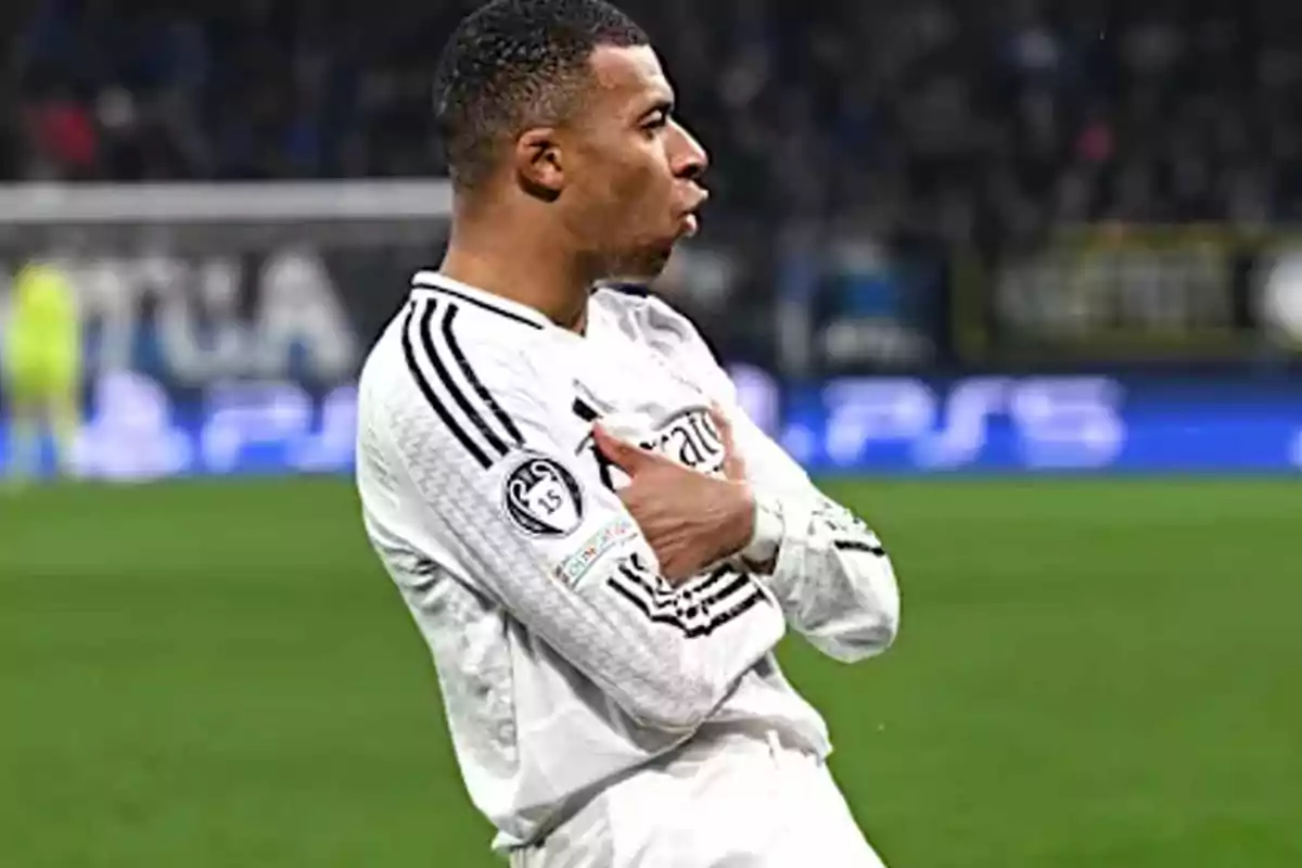 A soccer player celebrating a goal on the field in a white uniform. A soccer player celebrating a goal on the field in a white uniform.