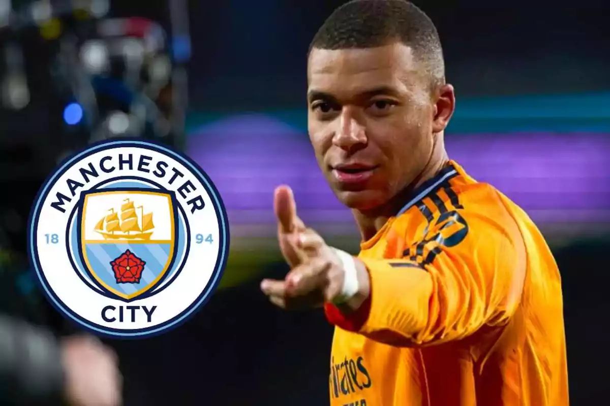 A player in an orange uniform points toward the camera, next to the Manchester City crest.