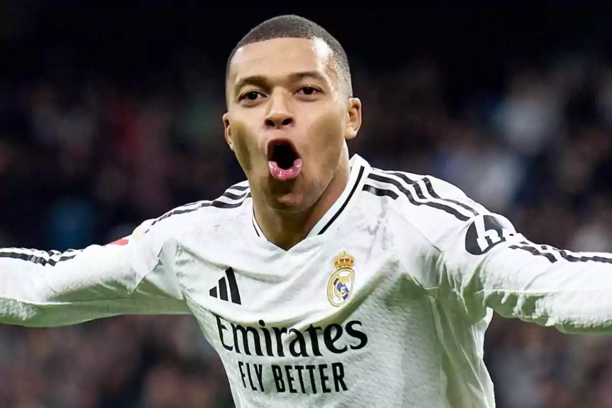 A soccer player celebrating a goal wearing a Real Madrid jersey.