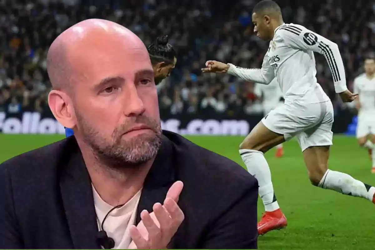 A bald man with a beard looks thoughtful as he watches a scene from a soccer match where a player in a white uniform is in action.