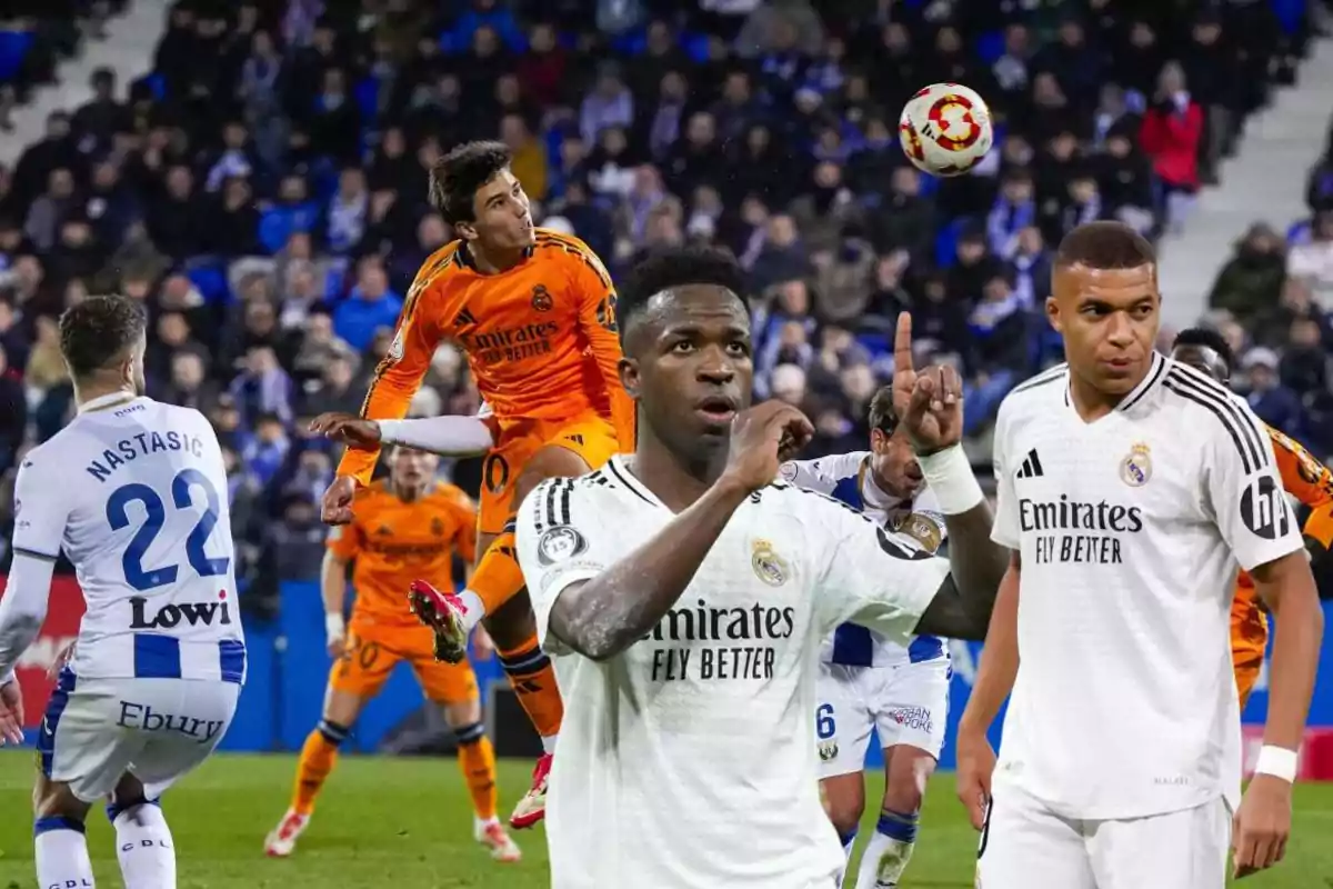 Soccer players in action during a match, with one of them celebrating and others watching the ball in the air.