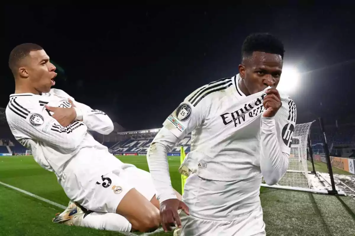 Two footballers celebrating a goal in a soccer stadium.