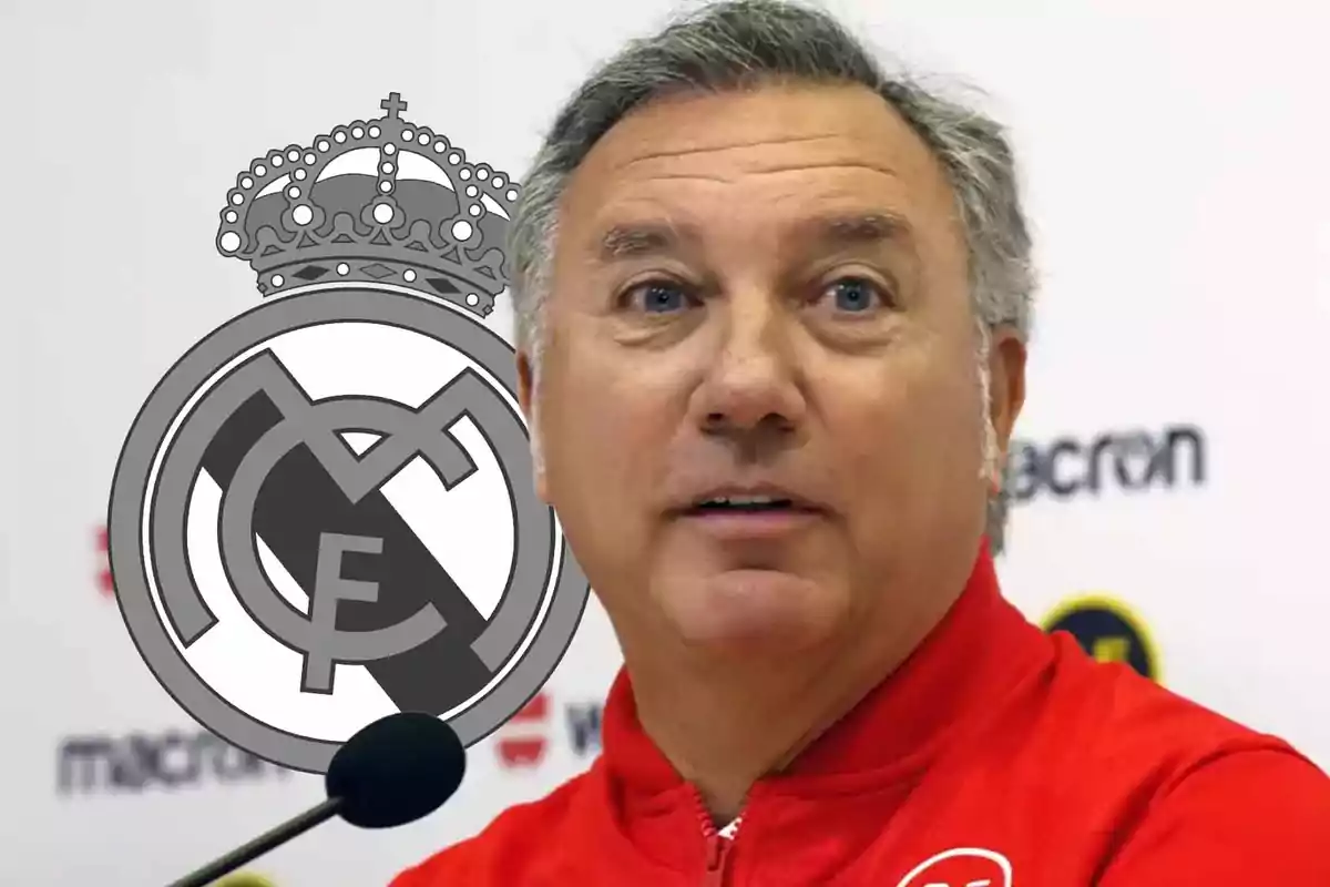 A man in a red jacket in front of a microphone with the Real Madrid crest in the background.