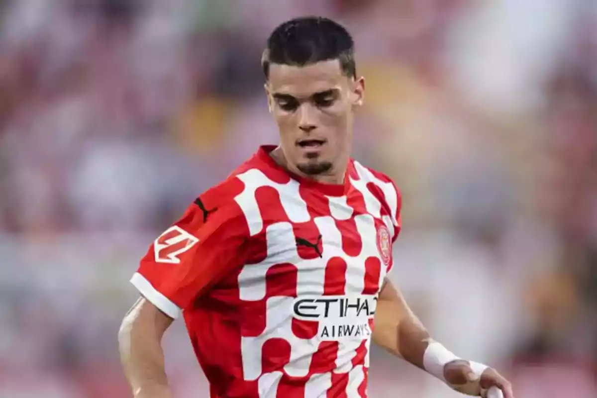 A player in a red and white jersey on the field. A player in a red and white jersey on the field.