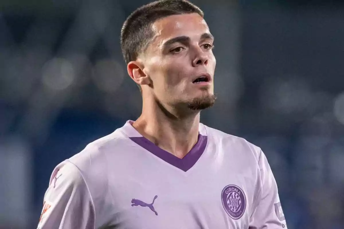 A player wearing a purple Girona FC jersey on the field. A player wearing a purple Girona FC jersey on the field.