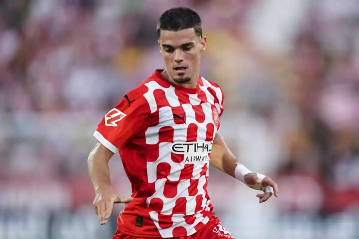 A soccer player in a red and white uniform in action during a match. A soccer player in a red and white uniform in action during a match.