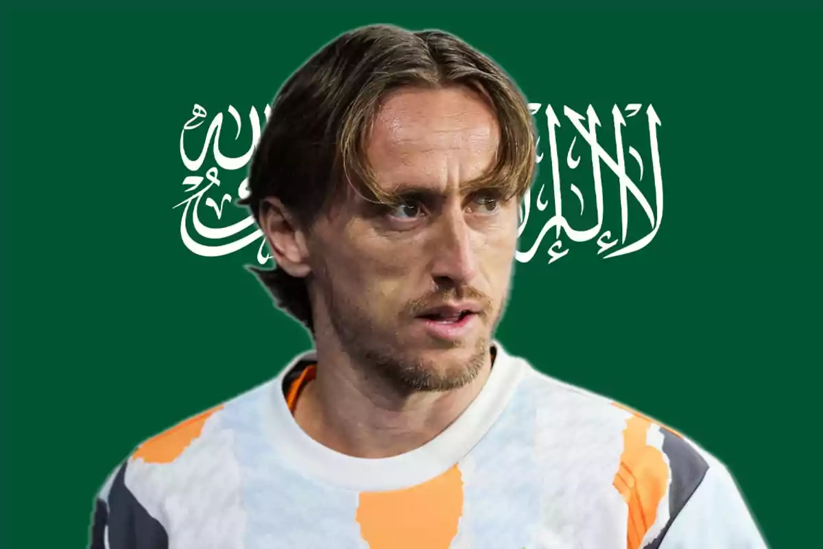 A man in a sports jersey in front of a green background with Arabic writing.