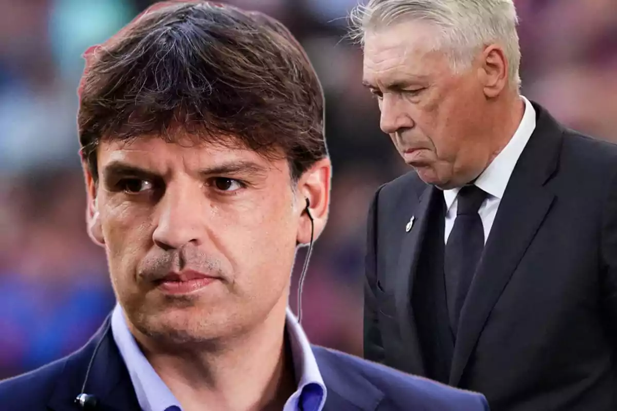 Dos hombres en traje, uno con auriculares y el otro con expresión seria, en un entorno deportivo.