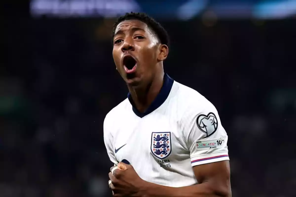 Soccer player in England national team uniform celebrating enthusiastically during a match Soccer player in England national team uniform celebrating enthusiastically during a match