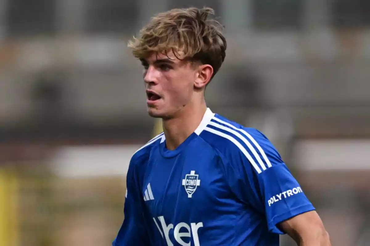 Football player in a blue jersey during a match. Football player in a blue jersey during a match.