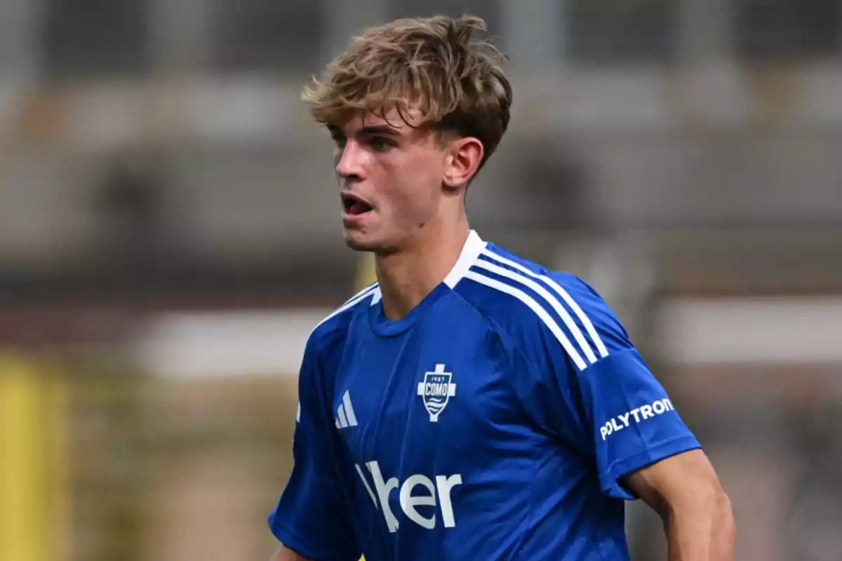Football player in a blue jersey during a match. Football player in a blue jersey during a match.