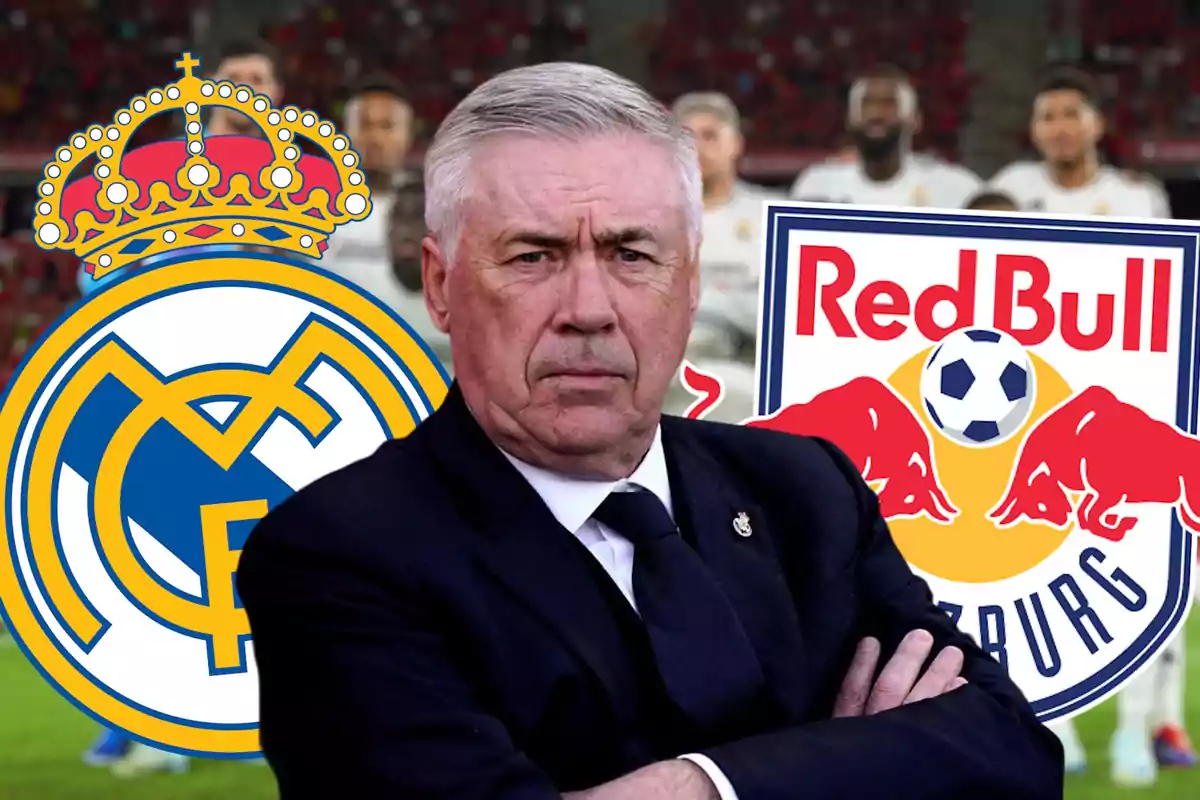 A man in a suit with his arms crossed stands in front of the logos of Real Madrid and Red Bull Salzburg.