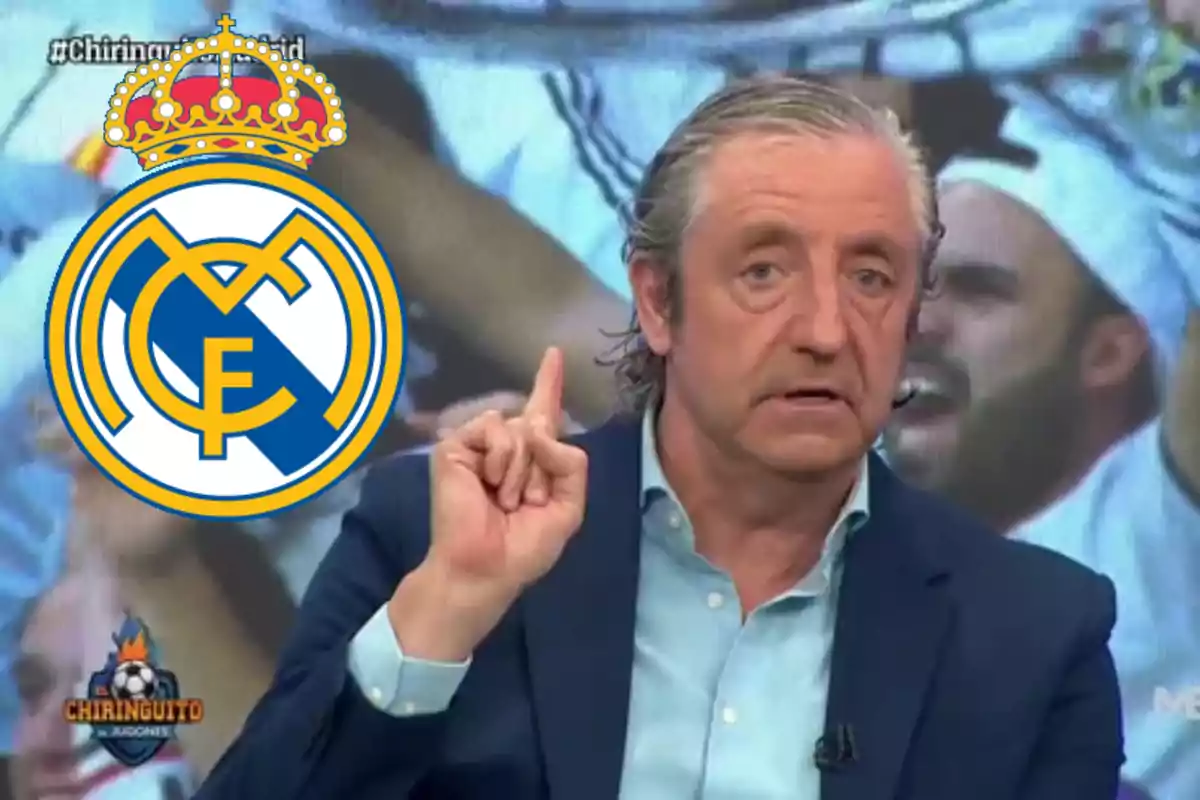 Gray-haired man in a blue suit raising a finger while the Real Madrid crest appears next to him on a television show