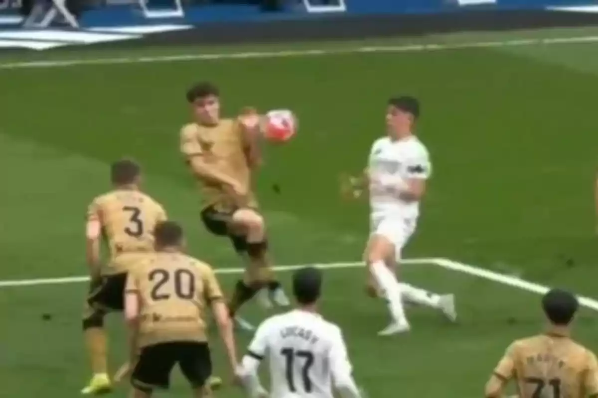 Soccer players in action during a match, one of them seems to be controlling the ball with his chest while others watch. Soccer players in action during a match, one of them seems to be controlling the ball with his chest while others watch.