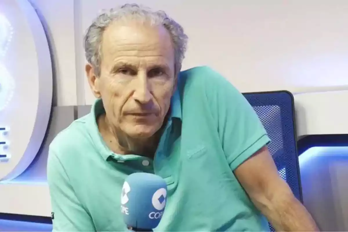 Older man in aqua green jersey in a radio studio holding a blue microphone. Older man in aqua green jersey in a radio studio holding a blue microphone.