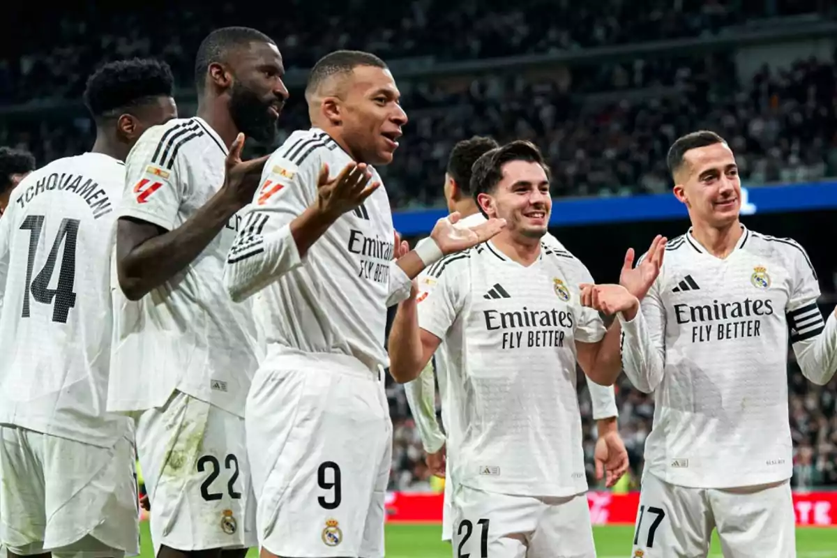 Real Madrid soccer players celebrating on the field with expressions of joy and surprise. Real Madrid soccer players celebrating on the field with expressions of joy and surprise.