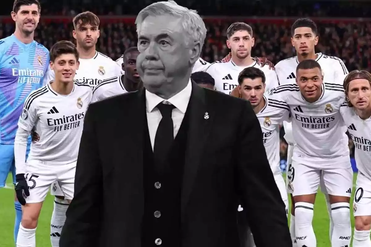 A soccer coach in the foreground with a group of Real Madrid players in the background.