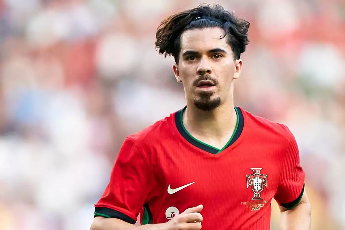 A football player in a red jersey on the field. A football player in a red jersey on the field.