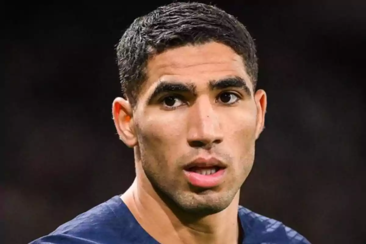 A man with short hair and a serious expression looking to the side. A man with short hair and a serious expression looking to the side.