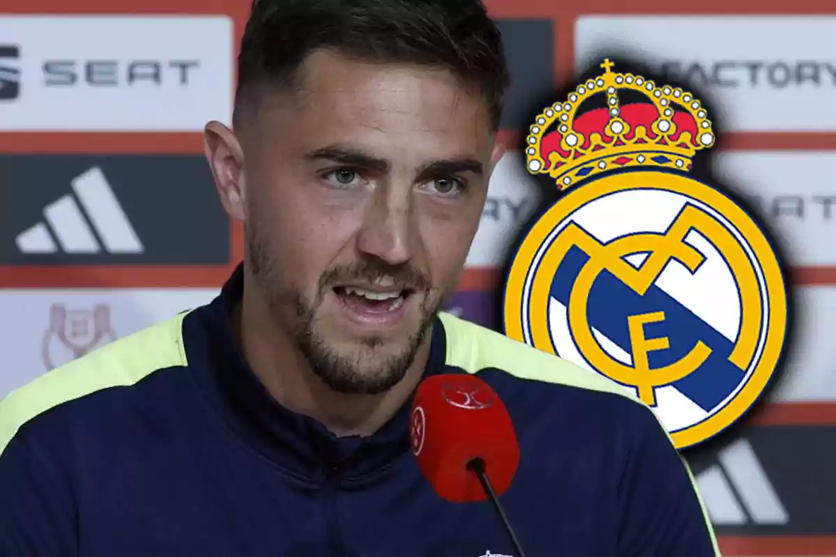 A man speaking at a press conference with the Real Madrid logo in the background.