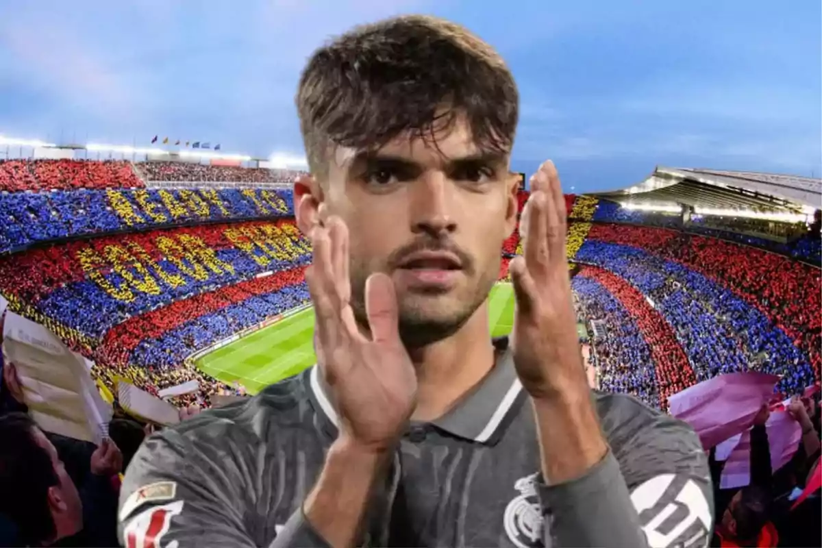 A player clapping with a stadium full of fans in the background.