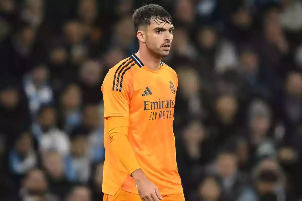 Real Madrid goalkeeper wearing an orange uniform during a soccer match Real Madrid goalkeeper wearing an orange uniform during a soccer match