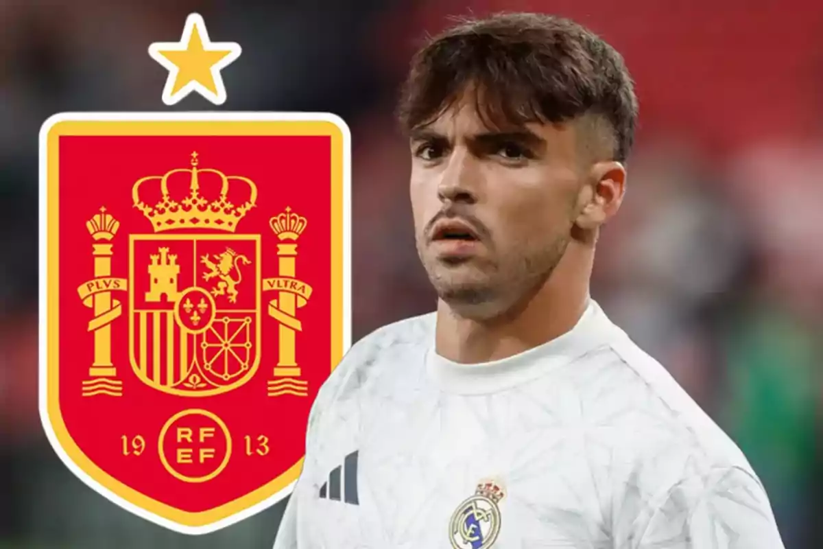 A player in a white jersey is next to the Spanish national team crest.