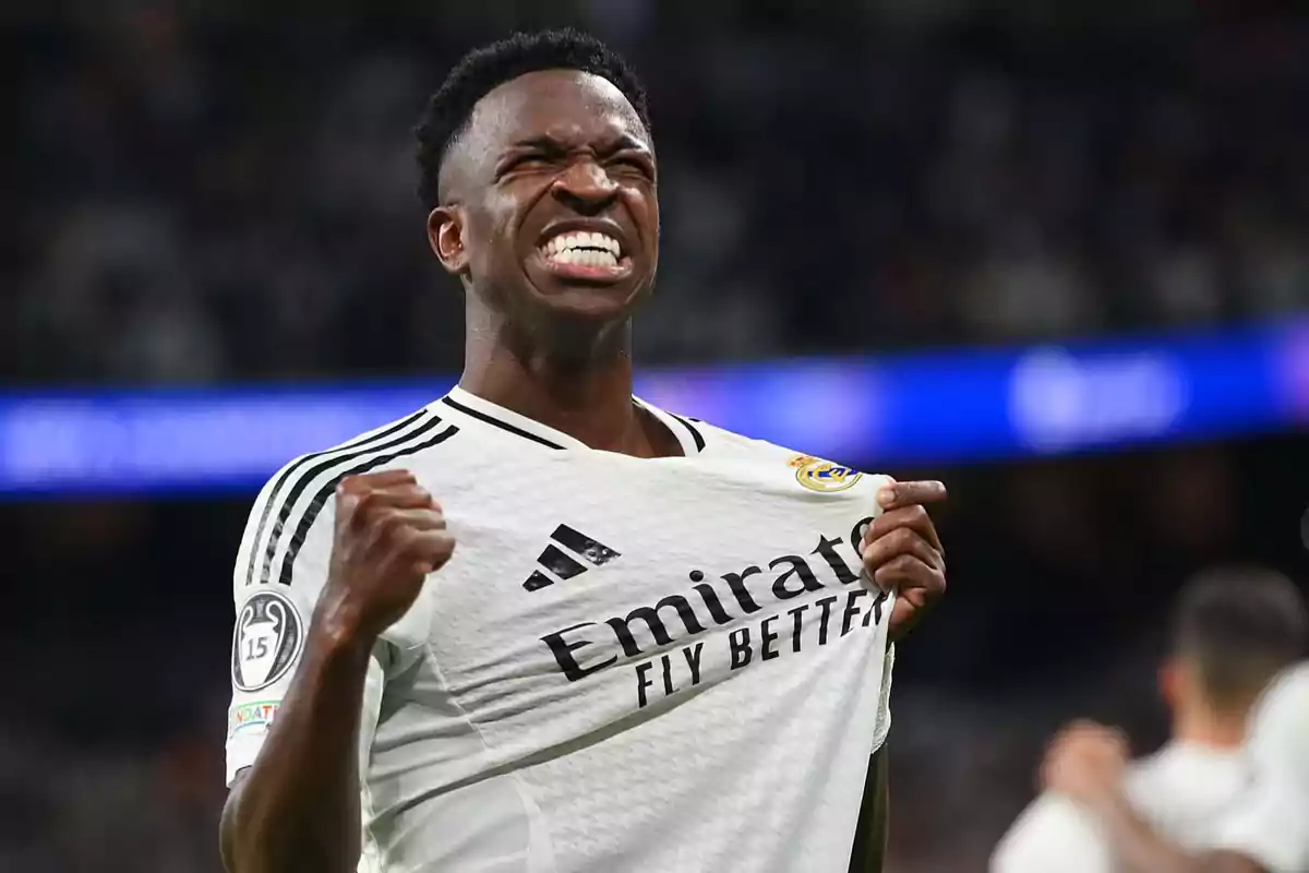 Soccer player celebrating with excitement while holding his team's jersey.