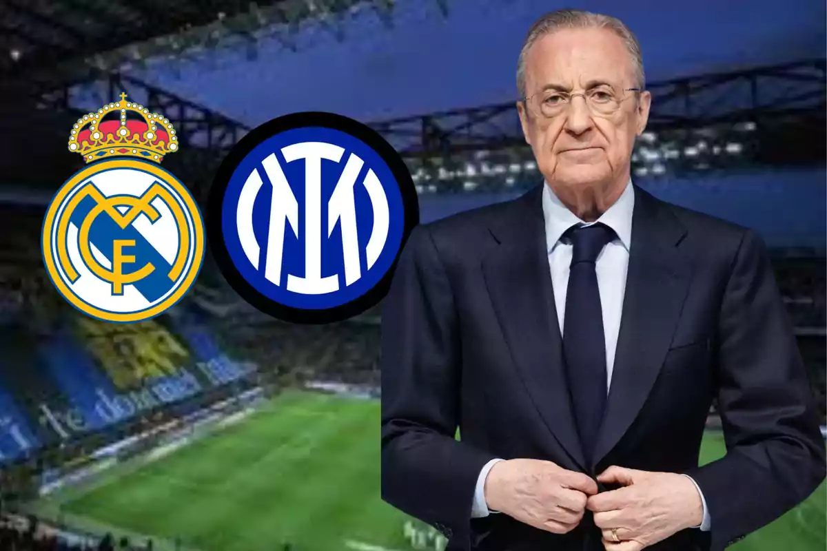 A man in a suit stands in front of the logos of Real Madrid and Inter Milan in a soccer stadium.