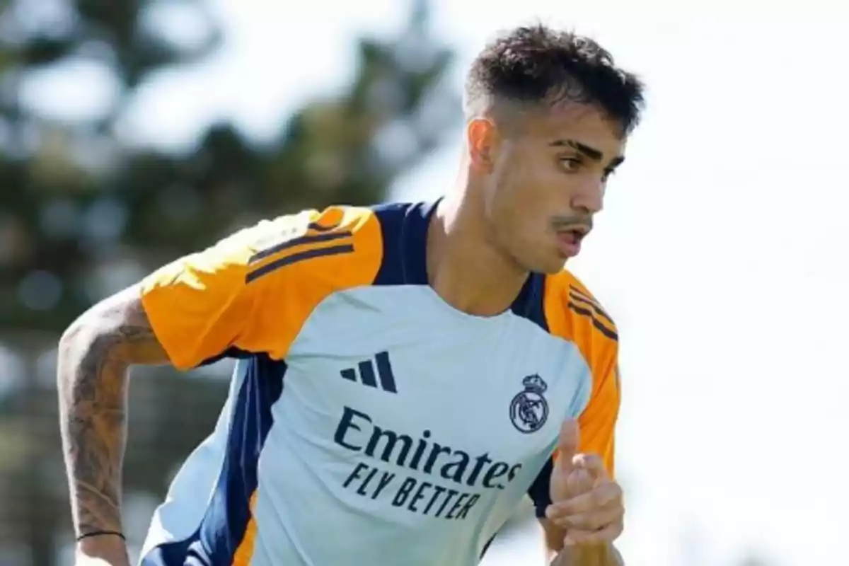 Soccer player training in a Real Madrid uniform on an outdoor field Soccer player training in a Real Madrid uniform on an outdoor field