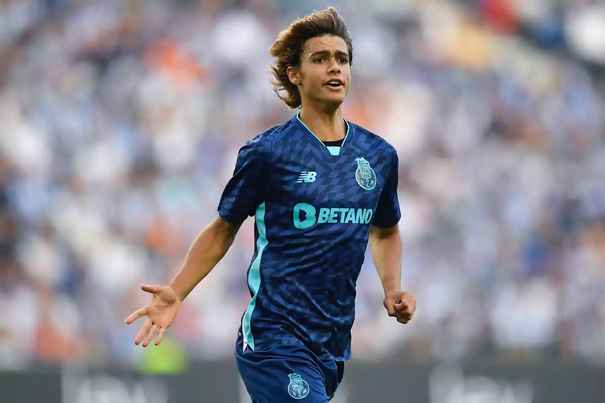A player in a dark blue uniform runs on the field during a match. A player in a dark blue uniform runs on the field during a match.