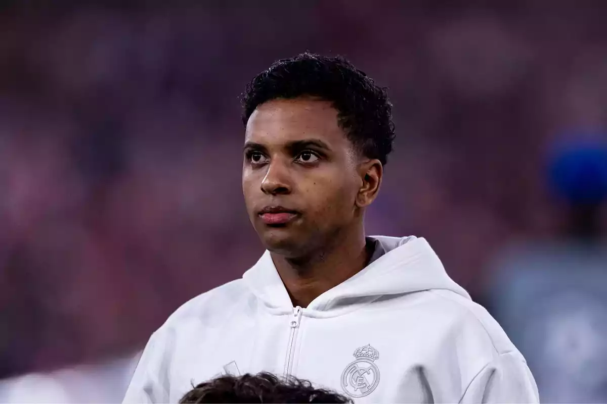 Soccer player wearing a white Real Madrid jacket in a stadium Soccer player wearing a white Real Madrid jacket in a stadium