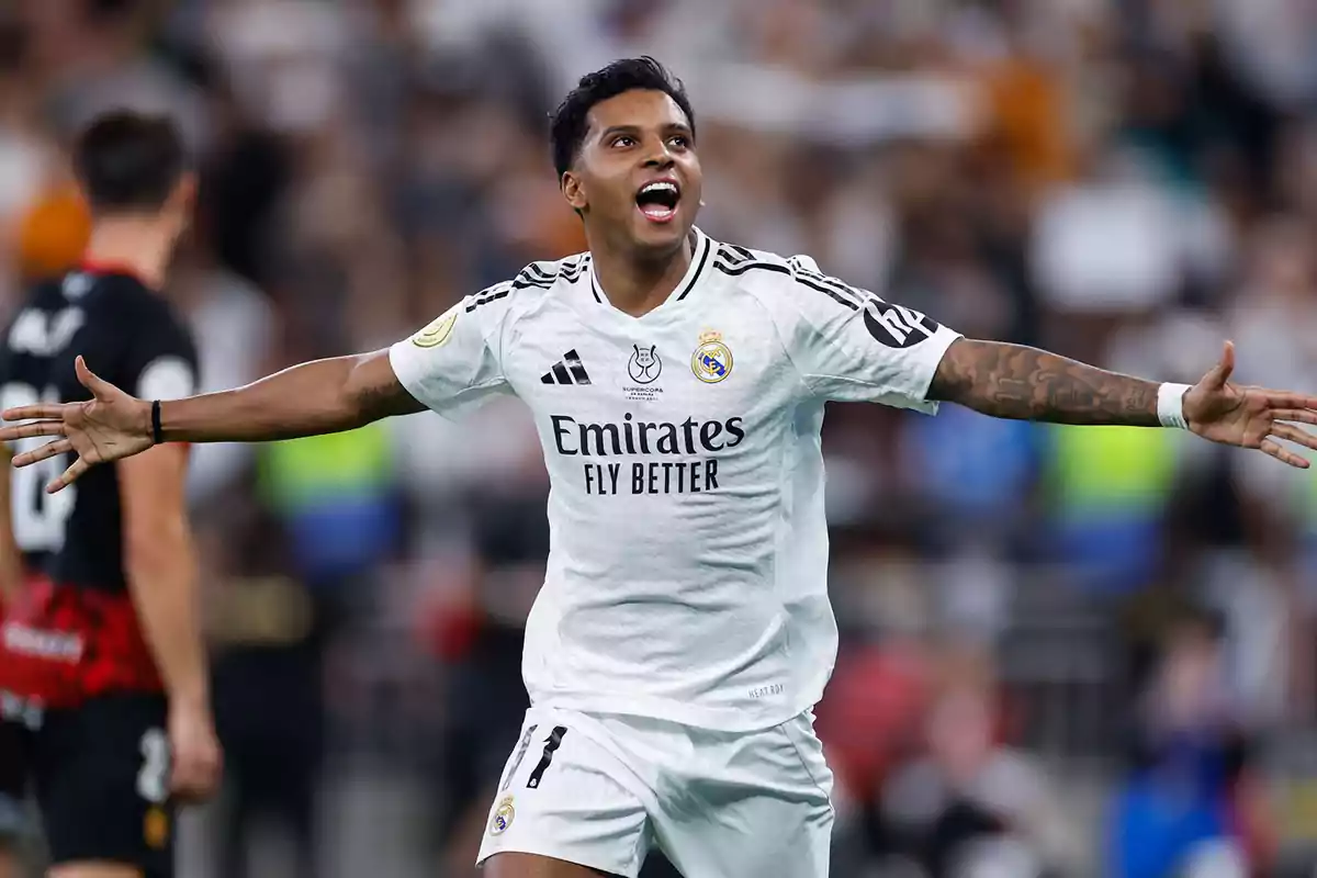 Soccer player celebrating a goal with his arms outstretched in a stadium. Soccer player celebrating a goal with his arms outstretched in a stadium.
