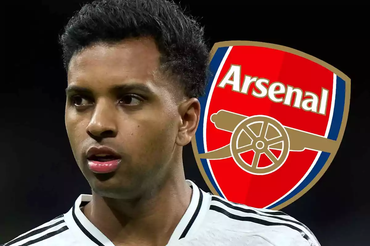 Soccer player wearing a white jersey with the Arsenal crest in the background