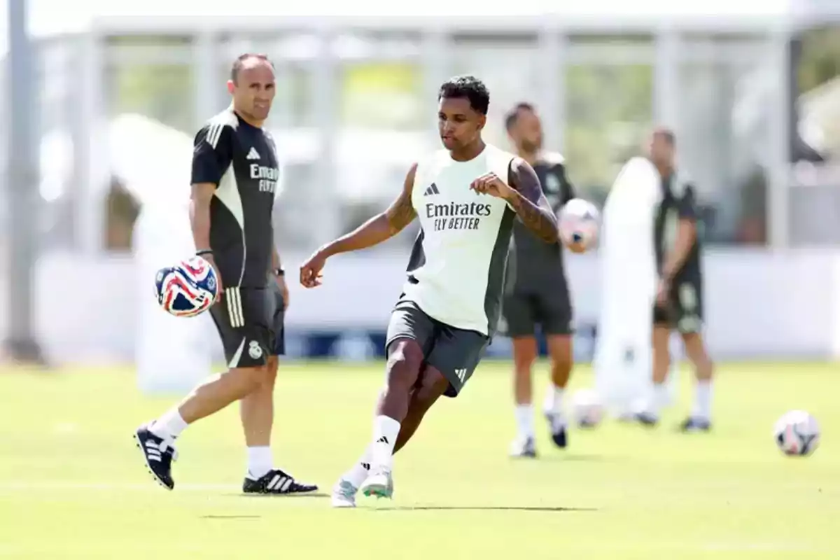 Soccer player training on the field with teammates and coach in the background Soccer player training on the field with teammates and coach in the background
