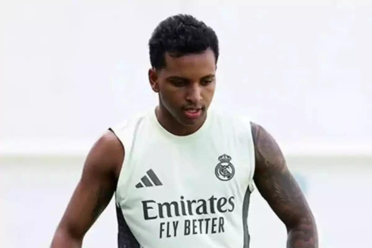 Soccer player wearing a Real Madrid training jersey on a sports field