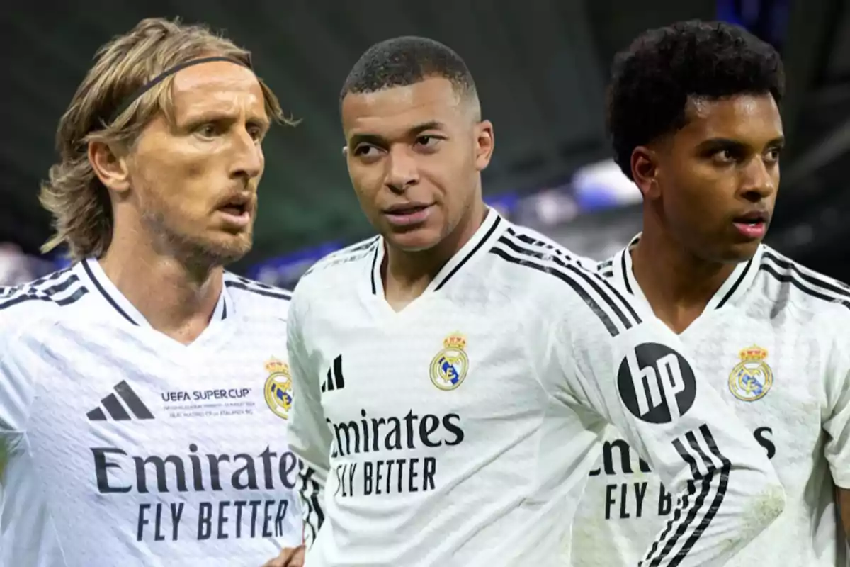 Three football players wearing Real Madrid uniforms pose together in a stadium.