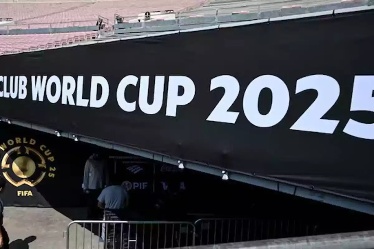Black sign with white letters announcing the 2025 Club World Cup in a stadium