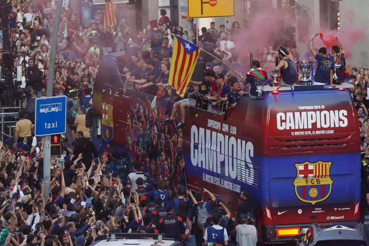 An open-top bus with players celebrates a championship as it moves down a street full of fans cheering and taking photos, with colored smoke and waving flags. An open-top bus with players celebrates a championship as it moves down a street full of fans cheering and taking photos, with colored smoke and waving flags.