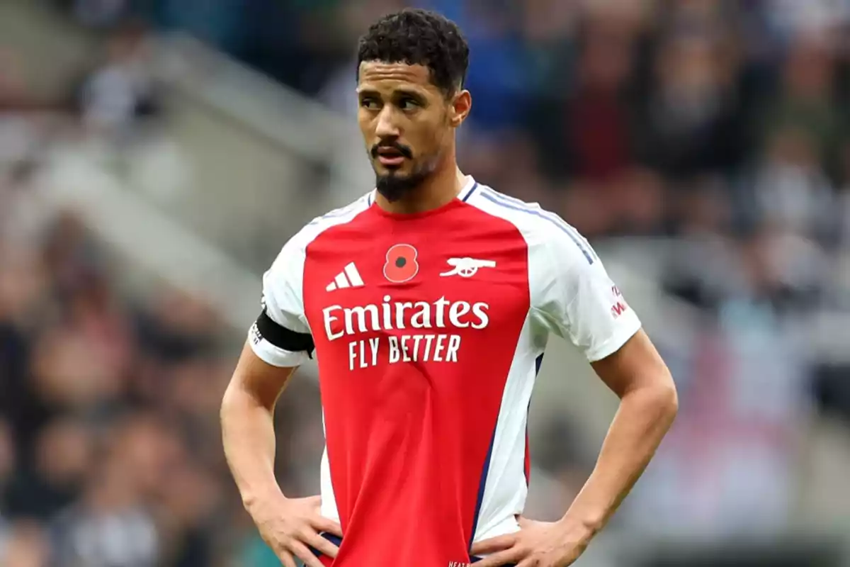 Football player in red and white Arsenal jersey on the field. Football player in red and white Arsenal jersey on the field.