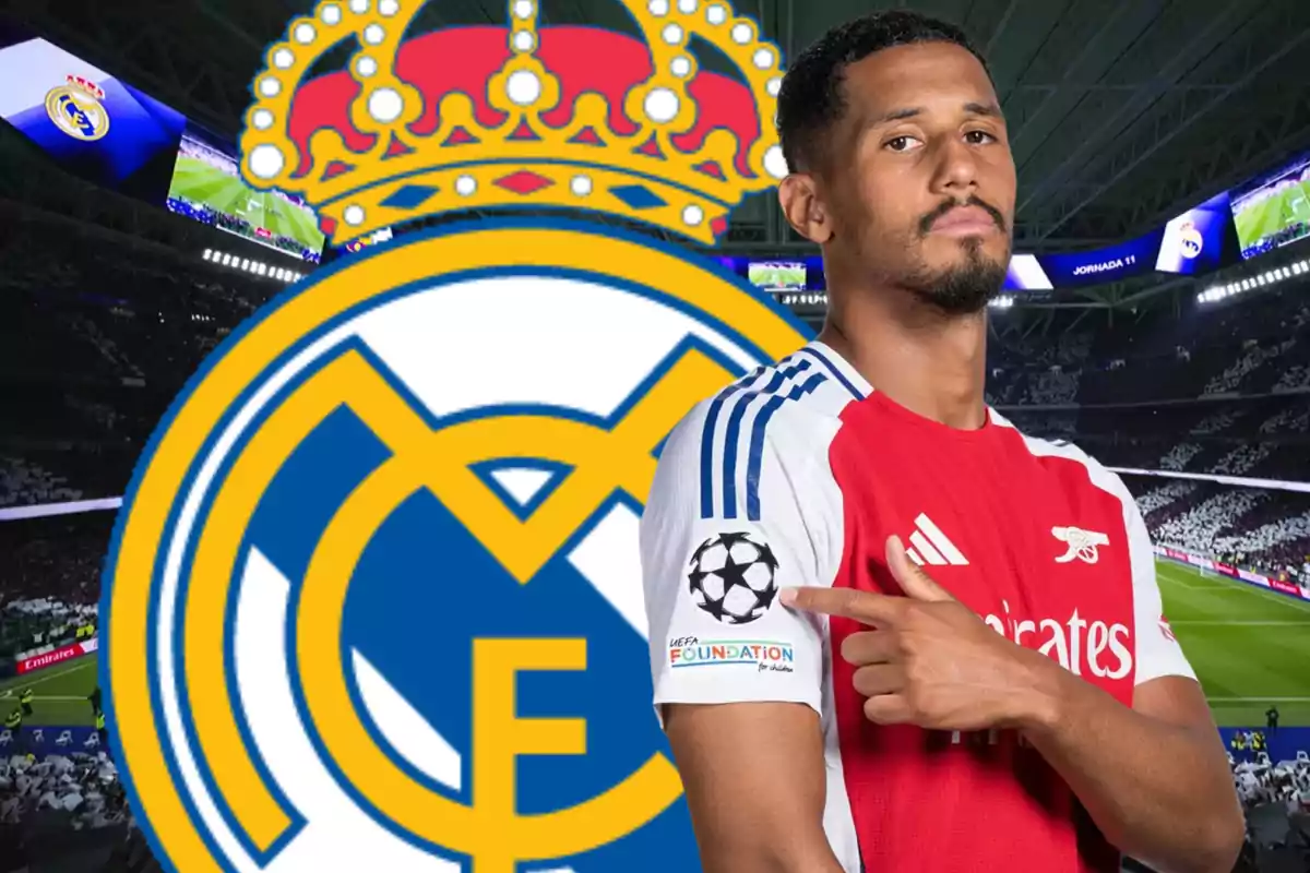 A player in a red and white uniform points to a UEFA patch on his arm, with the Real Madrid logo in the background at a stadium.