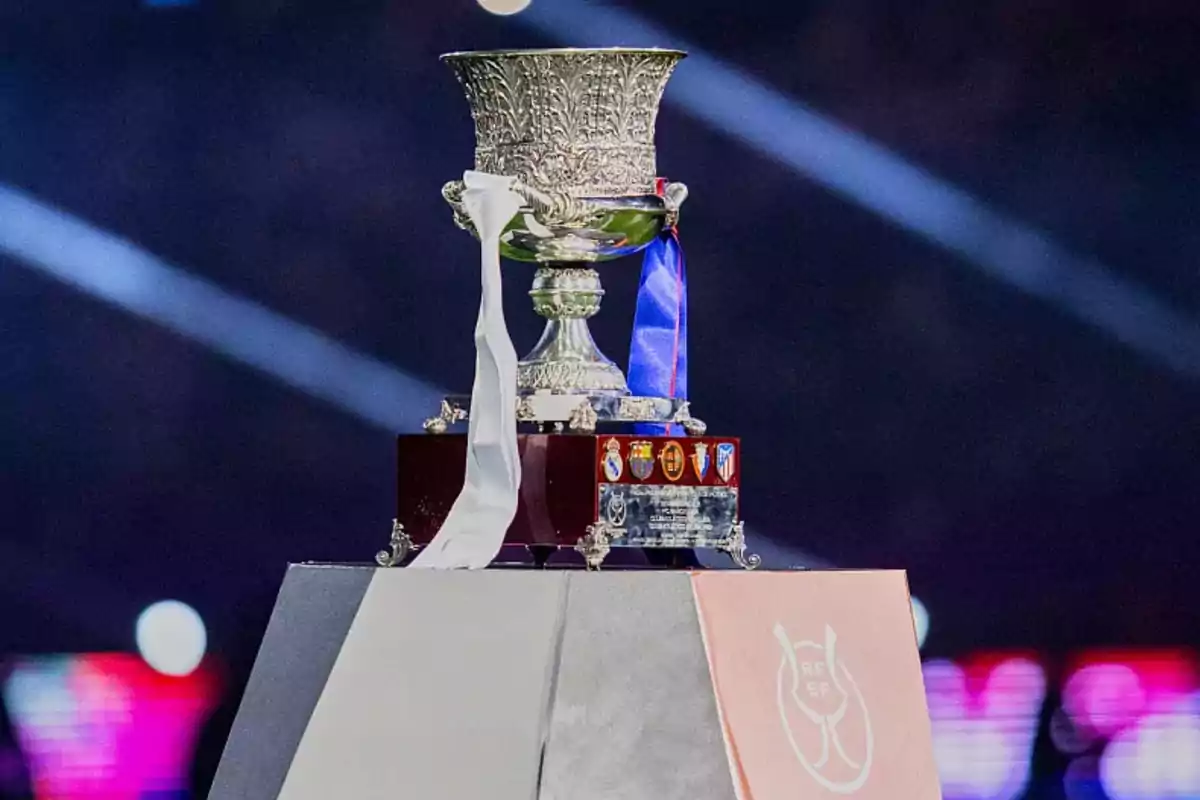 Spanish Super Cup trophy on a pedestal with white and blue ribbons. Spanish Super Cup trophy on a pedestal with white and blue ribbons.