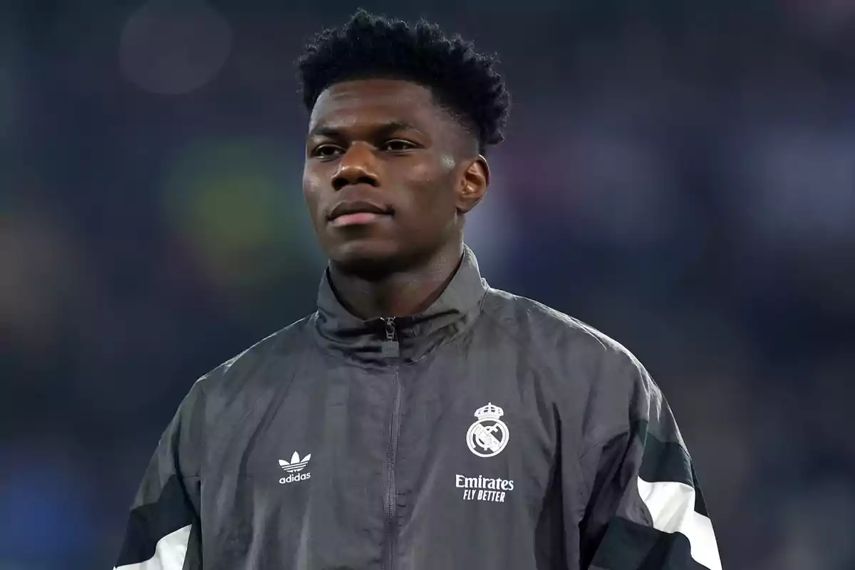 A soccer player wearing a Real Madrid jacket in a stadium. A soccer player wearing a Real Madrid jacket in a stadium.