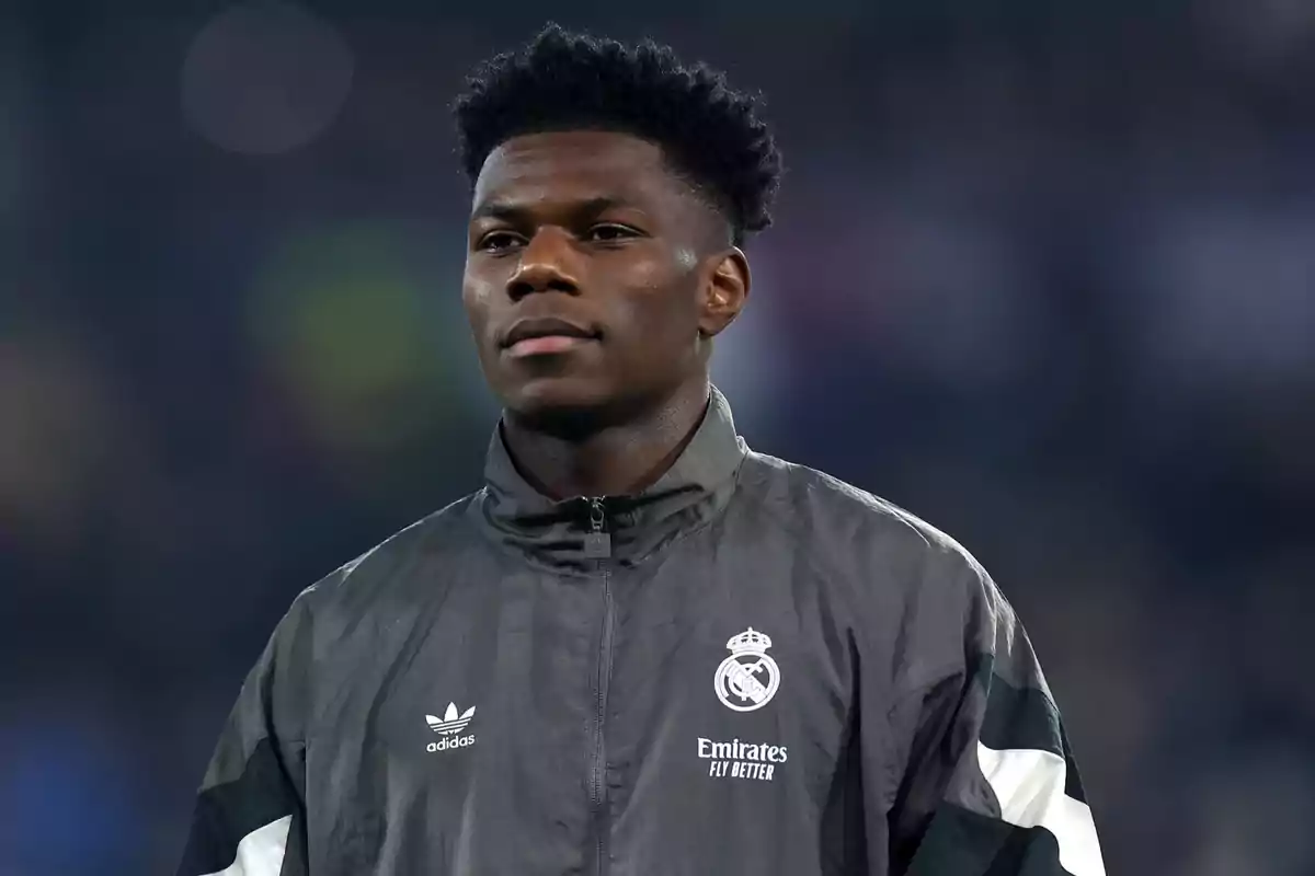 A soccer player wearing a Real Madrid jacket in a stadium. A soccer player wearing a Real Madrid jacket in a stadium.