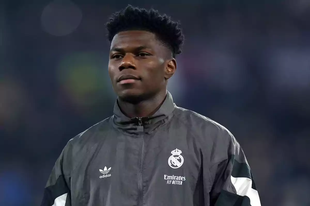 A soccer player wearing a Real Madrid jacket in a stadium. A soccer player wearing a Real Madrid jacket in a stadium.