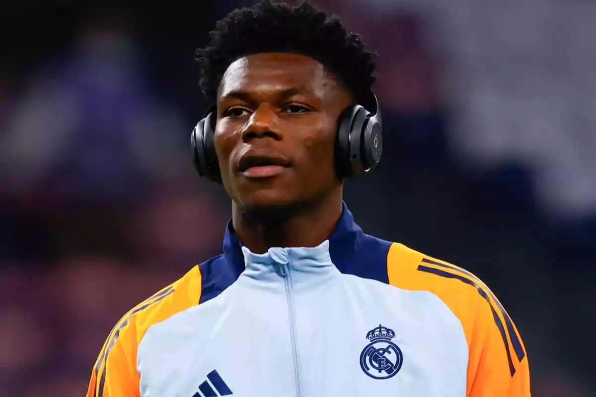 A soccer player with headphones and a Real Madrid jacket. A soccer player with headphones and a Real Madrid jacket.