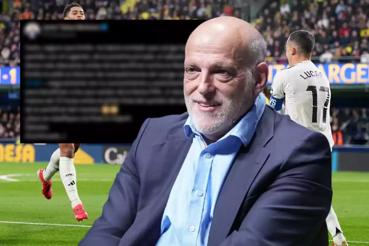 A bald man with a beard and a suit smiles while a soccer game with players in action is seen in the background.