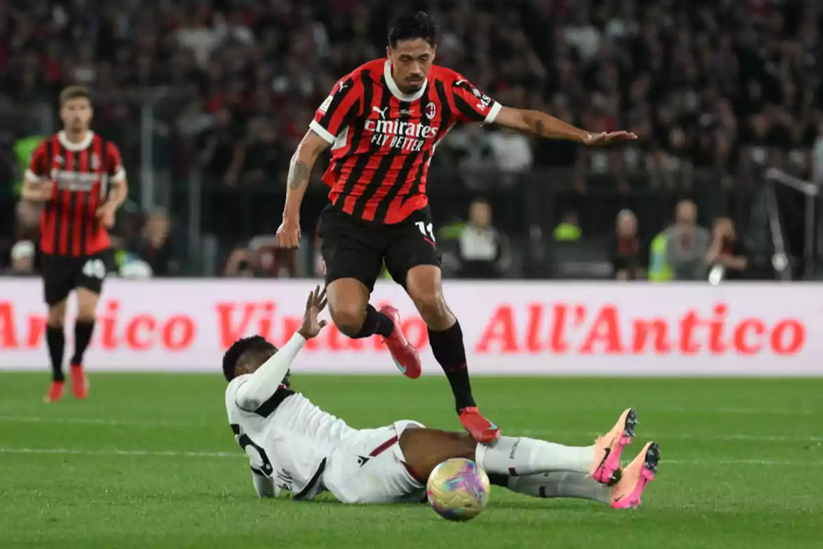 A player in a red and black uniform jumps over an opponent who is on the ground during a match. A player in a red and black uniform jumps over an opponent who is on the ground during a match.