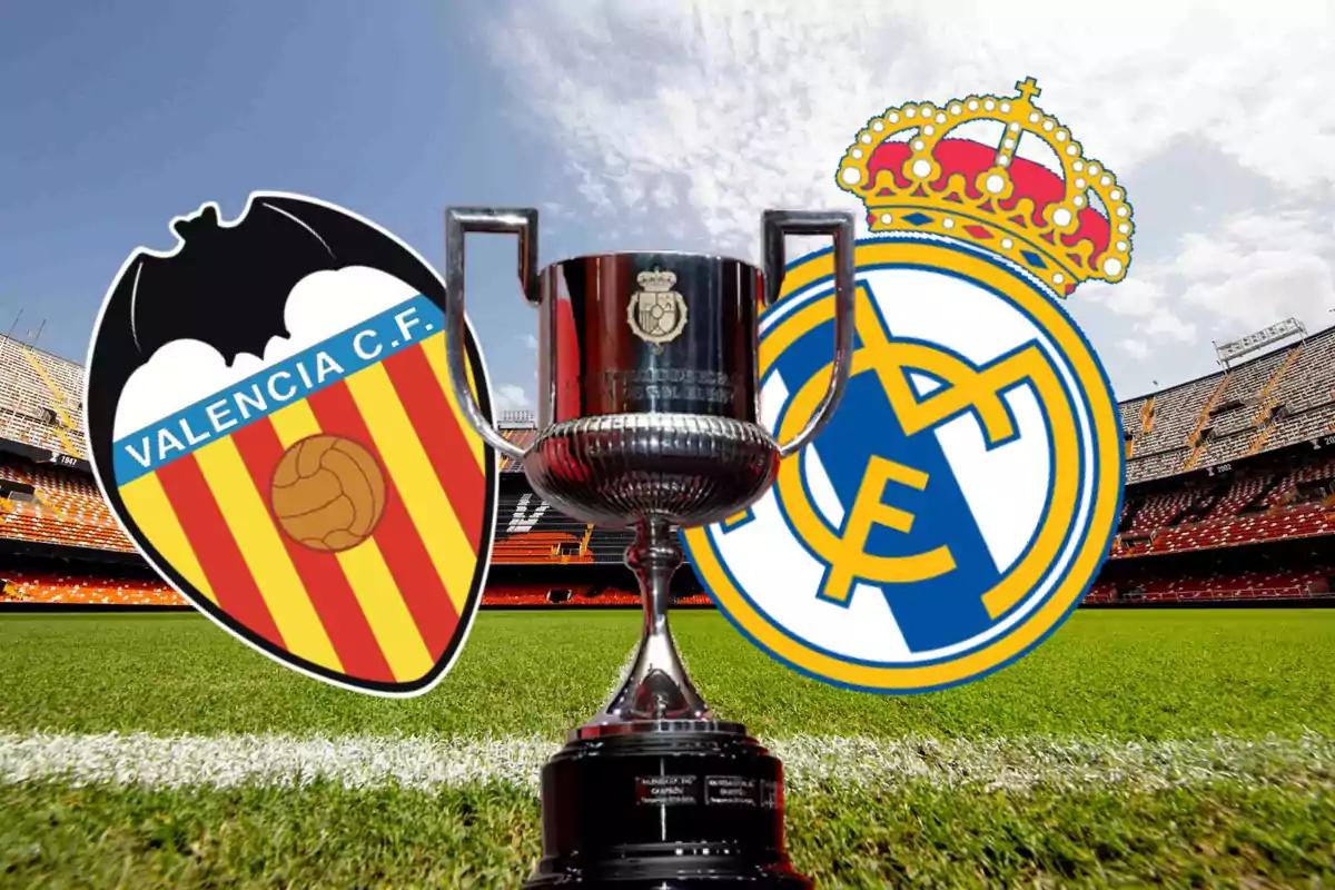 Valencia CF and Real Madrid shields with a trophy in the center on a soccer field.